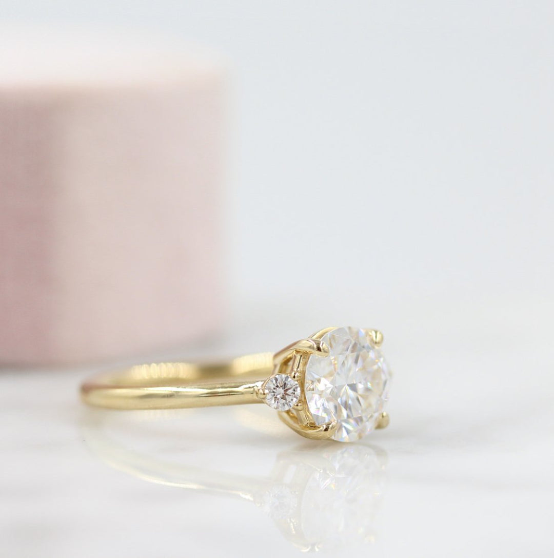 The Esme Ring (Round) in Yellow Gold with 2ct Moissanite against a white background