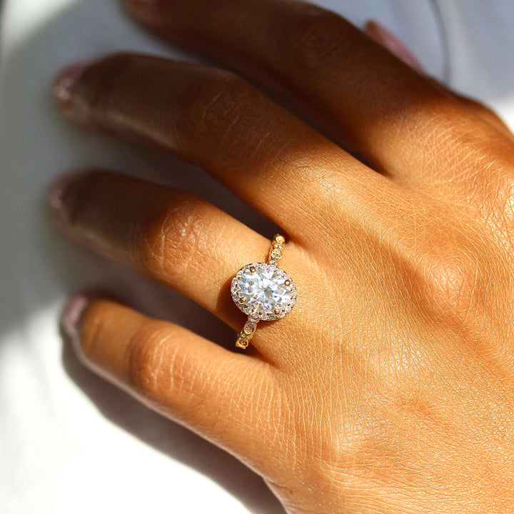 The Charlotte Ring (Oval) in Yellow Gold and Moissanite modeled on a hand