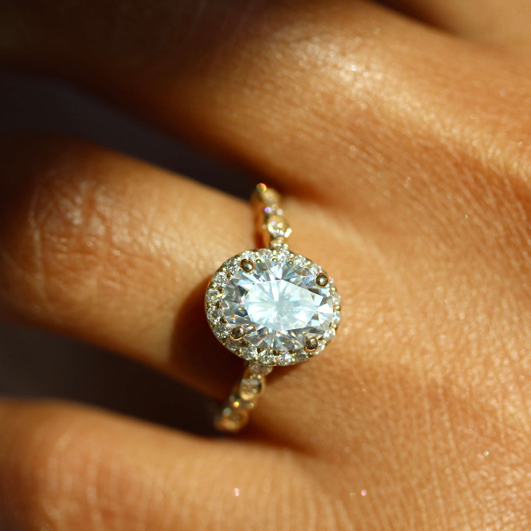 The Charlotte Ring (Oval) in Yellow Gold and Moissanite modeled on a hand