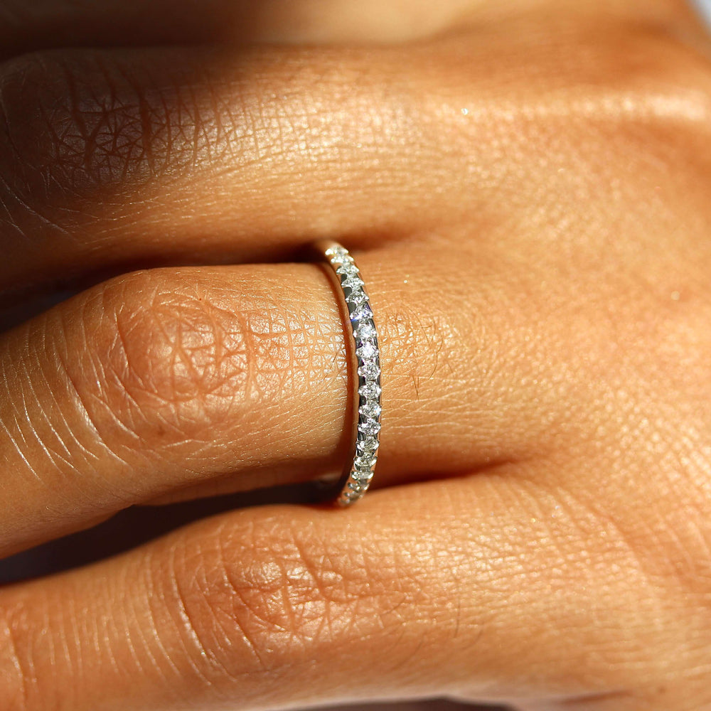 The Lauryn Wedding Band in white gold modeled on a hand