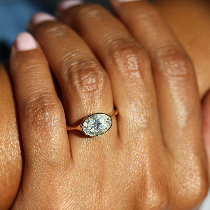 The Stevie Ring (East-West Oval) in Yellow Gold with 2ct Moissanite modeled on a hand