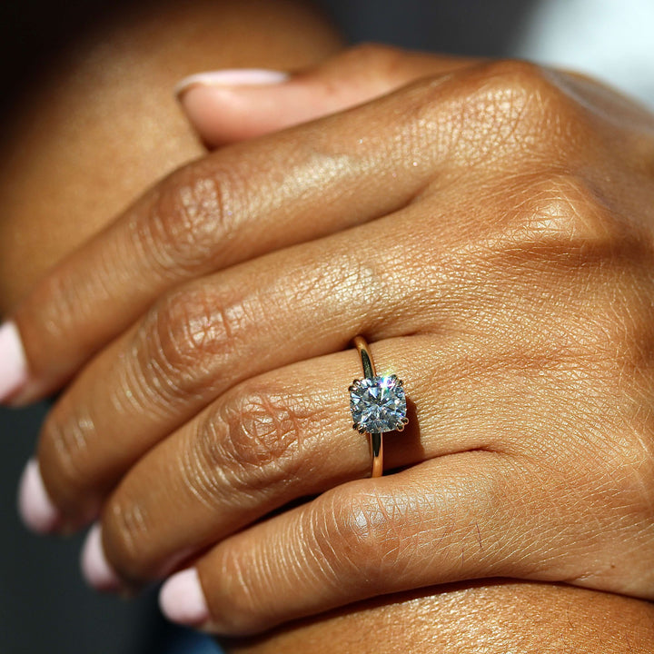 The Serena Ring (Square Cushion) in Yellow Gold and Moissanite modeled on a hand