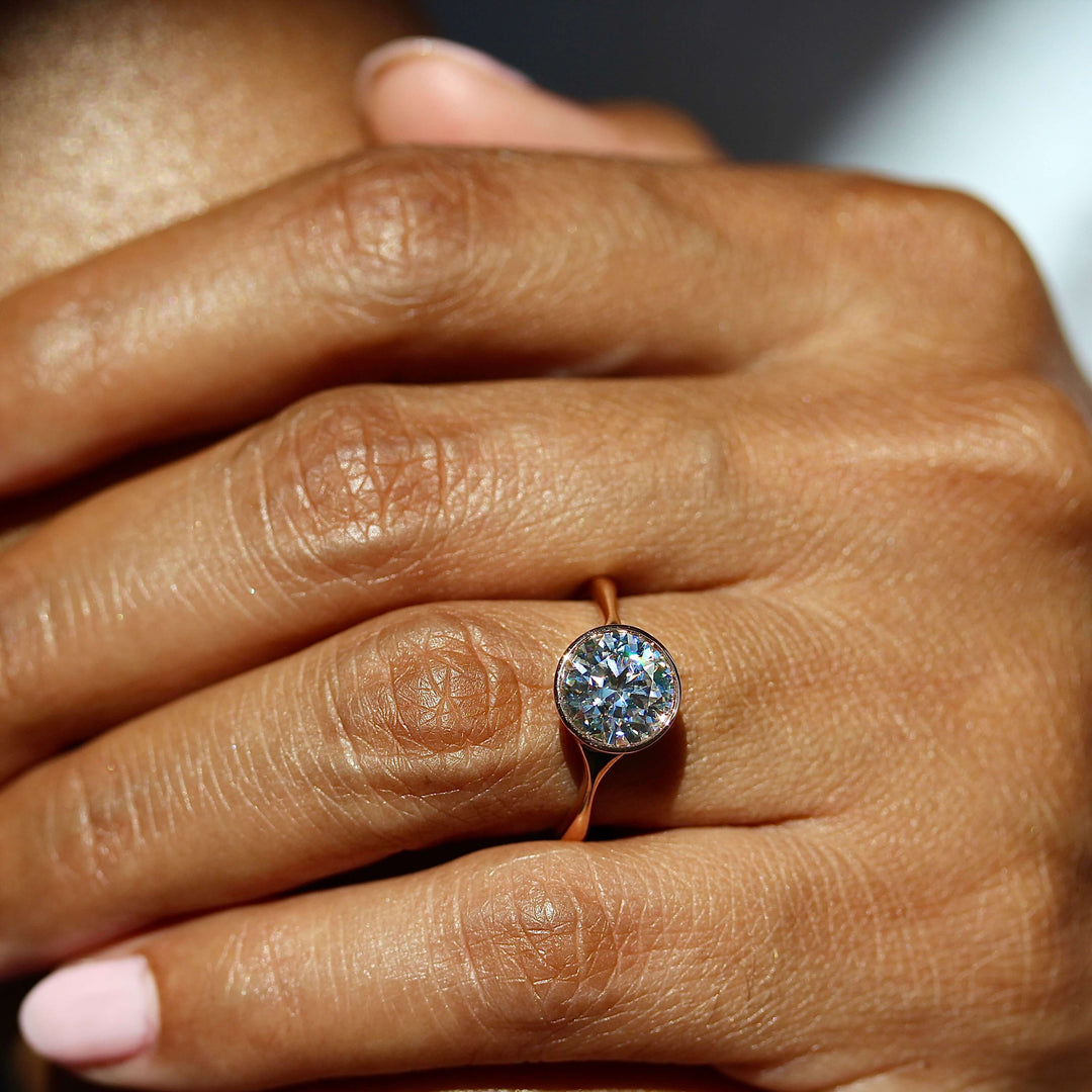 The Stevie Ring (Round) in Rose Gold with 2ct Moissanite modeled on a hand