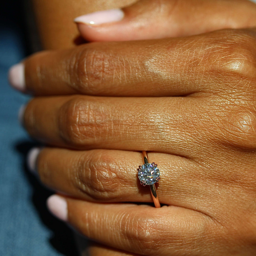 The Serena Ring (Round) in Rose Gold and Moissanite modeled on a hand