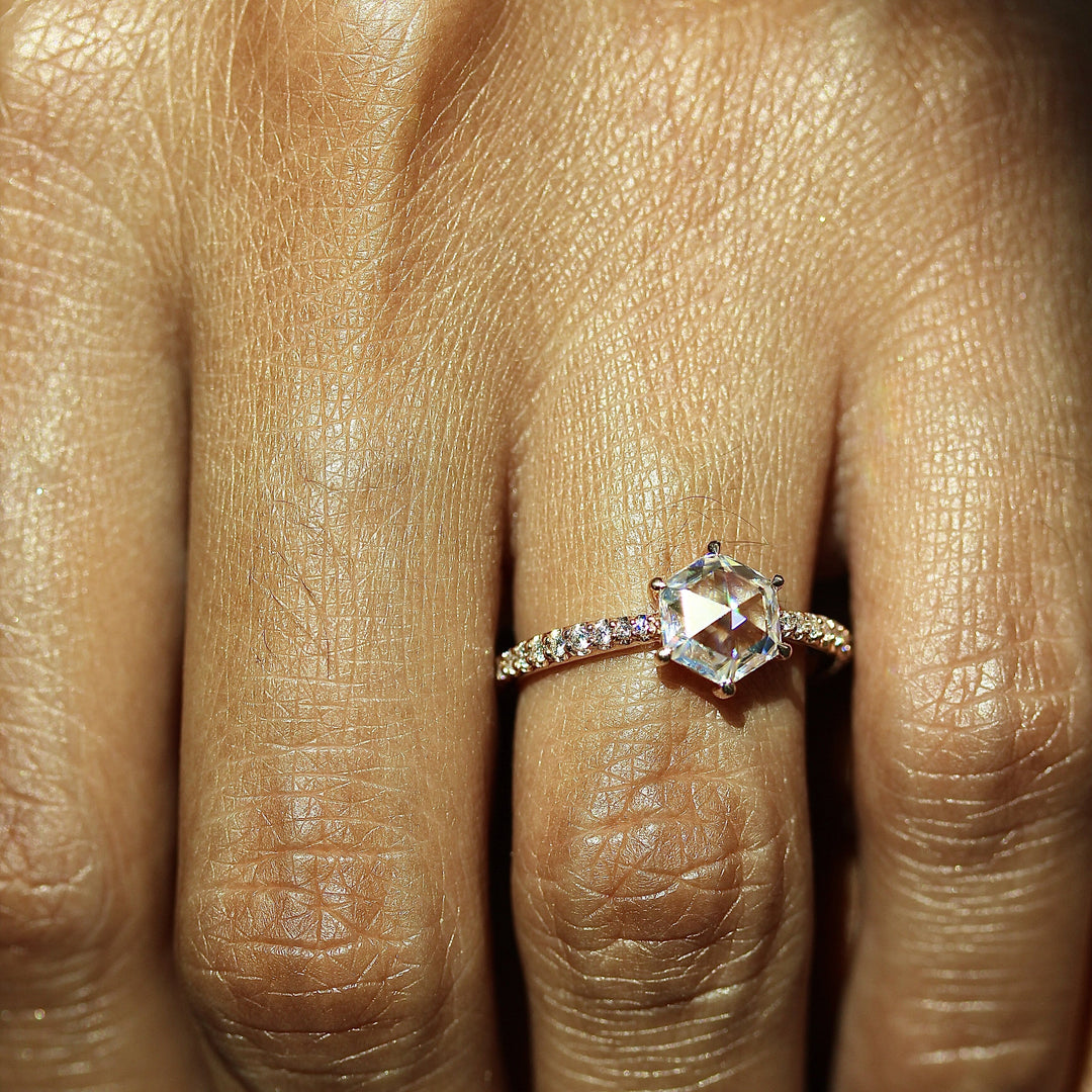 The Aurora Ring (Hexagon) in Rose Gold and Moissanite modeled on a hand
