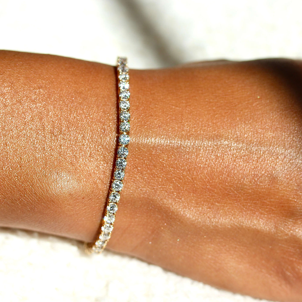 The Classic Lab Grown Diamond Tennis Bracelet in Yellow Gold and 7.04ct modeled on a hand