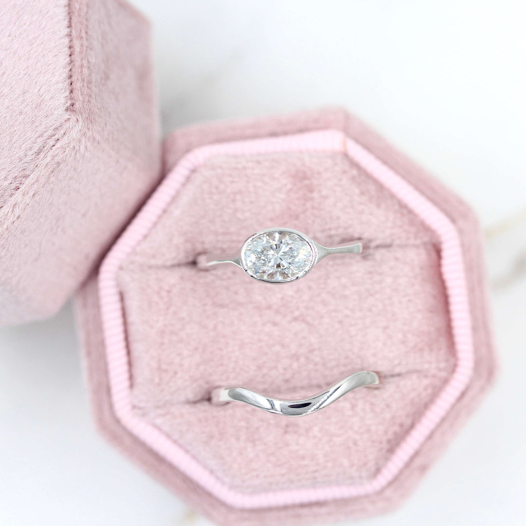 The Wave Wedding Band in White Gold with the Stevie Ring East-West Oval in White Gold in a pink velvet ring box