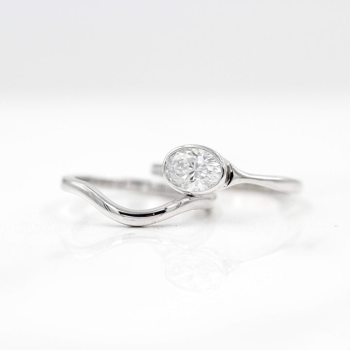 The Wave Wedding Band in White Gold with the Stevie Ring East-West Oval in White Gold against a white background