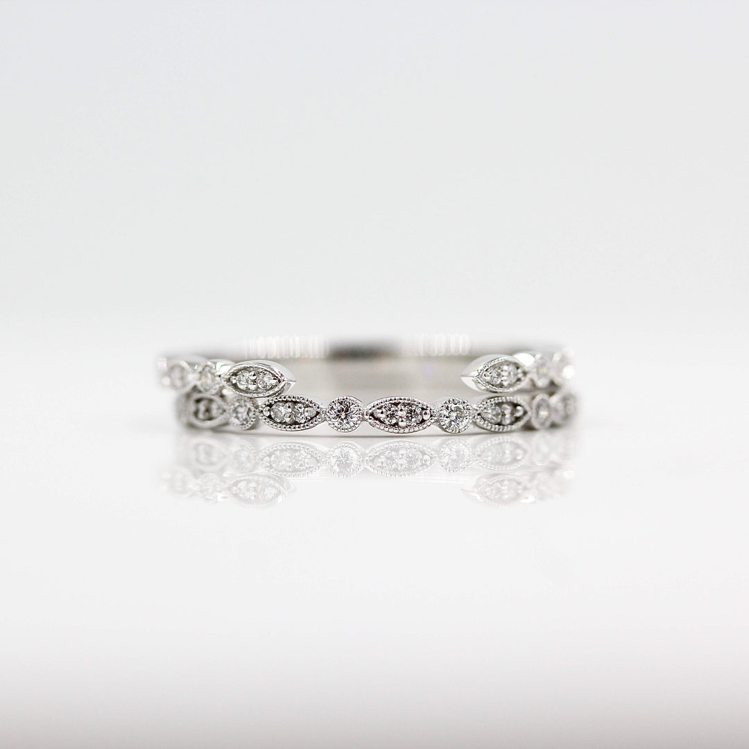 The Open Charlotte Wedding Band in white gold stacked on the Charlotte Wedding Band in white gold against a white background