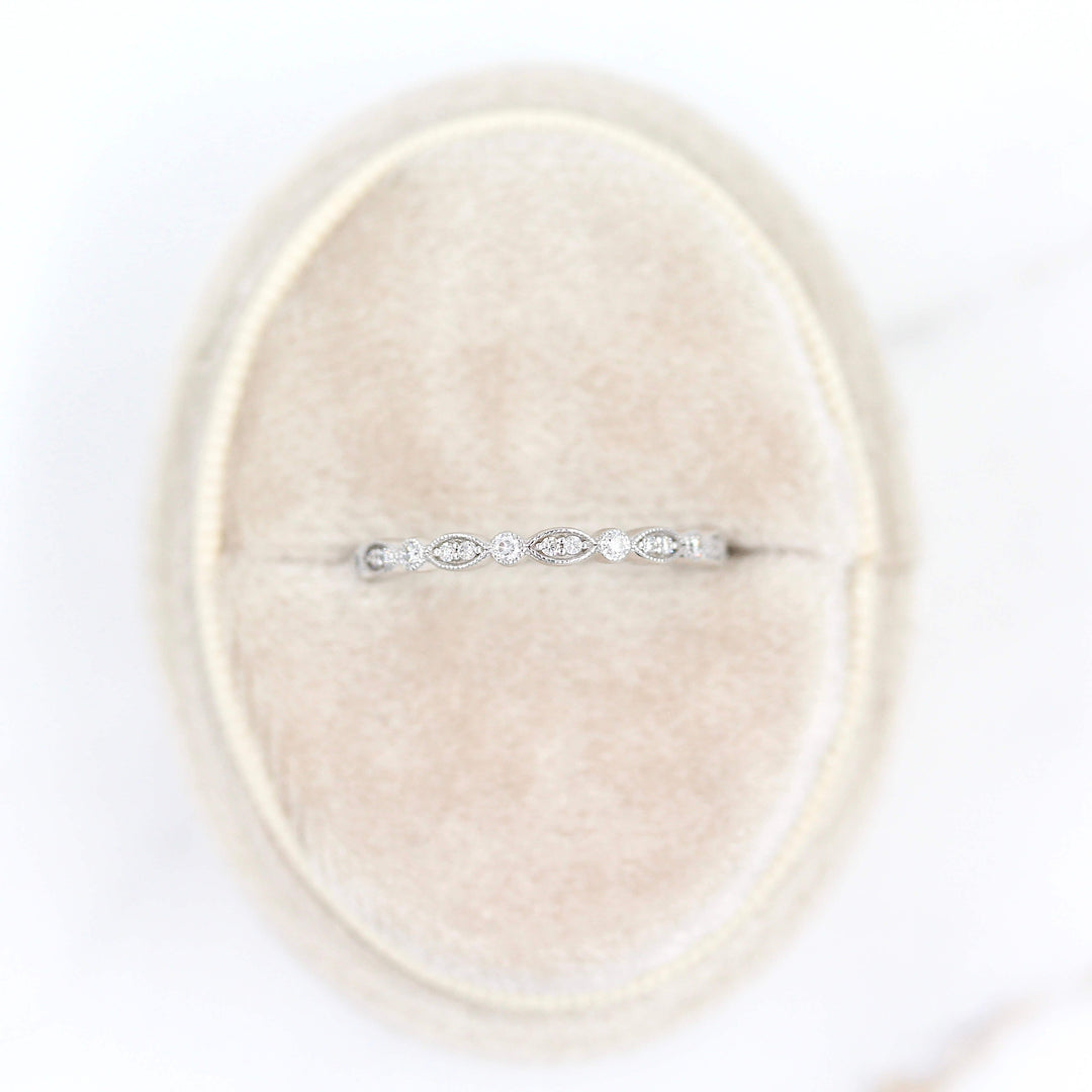 The Charlotte Wedding Band in White Gold in a tan velvet ring box