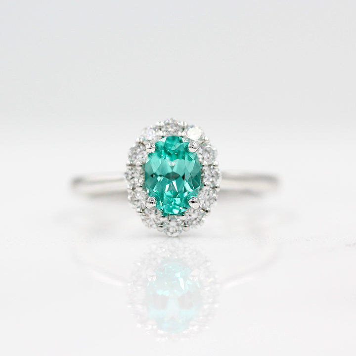 The Ava Ring with Minty Green Paraiba Color Chrysoberyl in white gold against a white background