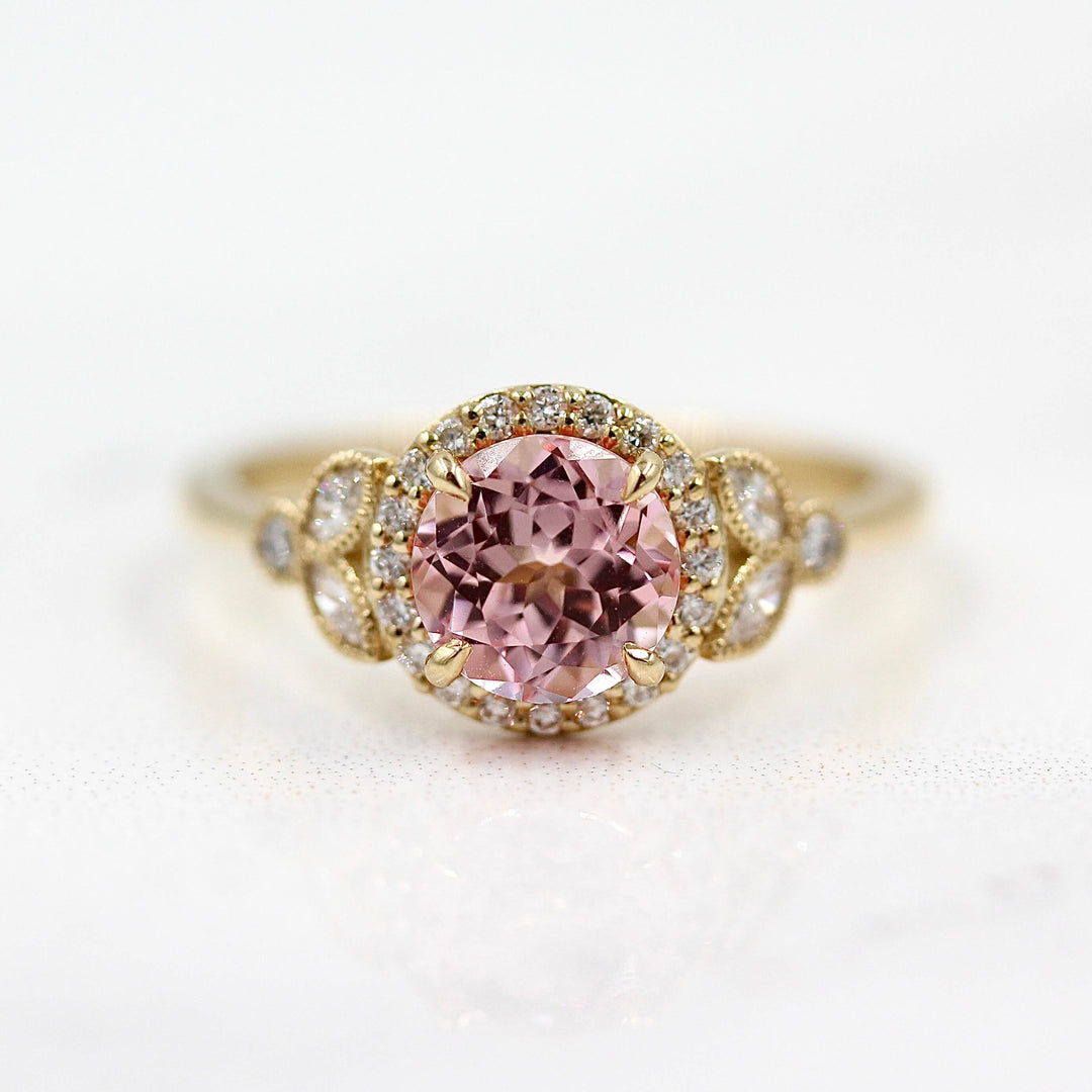 The Cate Ring (Round) in Yellow Gold and Peachy-Pink Created Sapphire against a white background