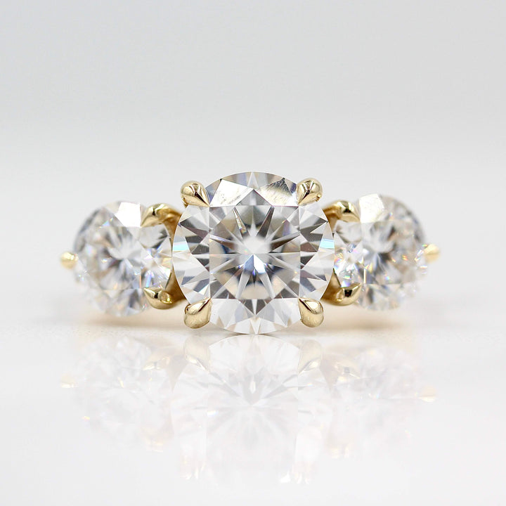 The Corrinne Hidden Halo Ring in Yellow Gold and Moissanite against a white background