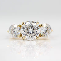 The Corrinne Hidden Halo Ring in Yellow Gold and Moissanite against a white background