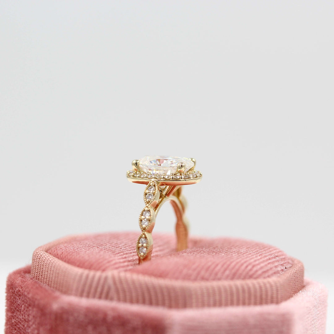 The Isla Ring (Oval) in Yellow Gold and Moissanite in a pink velvet ring box