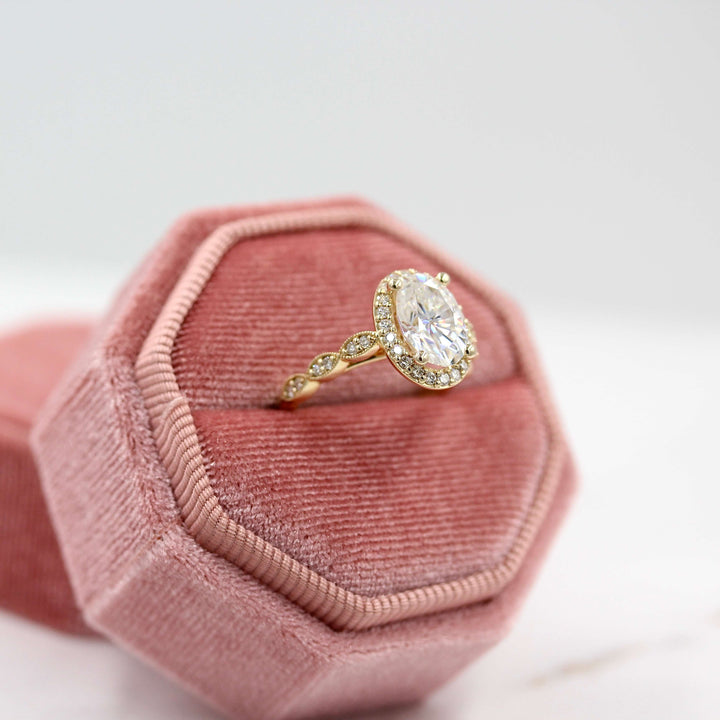 The Isla Ring (Oval) in Yellow Gold and Moissanite in a pink velvet ring box
