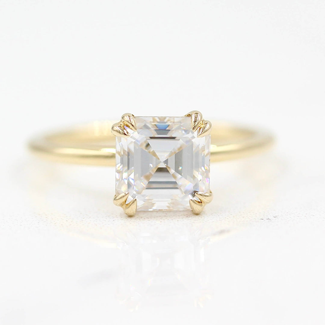 The Serena Ring (Asscher) in Yellow Gold and Moissanite against a white background