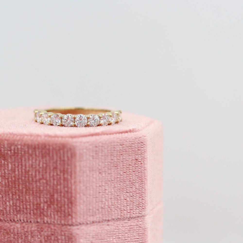 The Lexington Wedding Band in Yellow Gold atop a pink velvet ring box