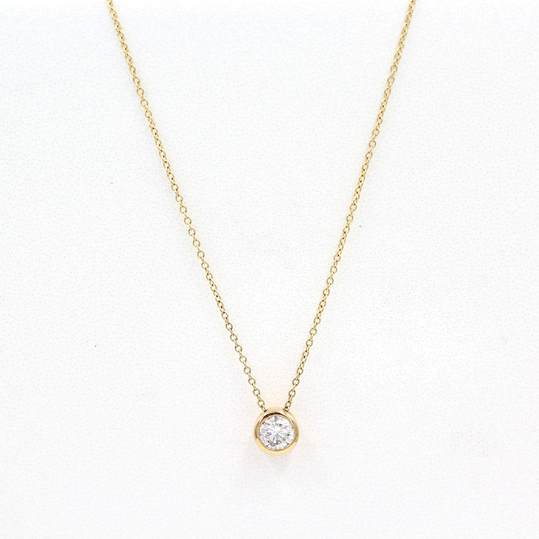 1/2ct Diamond Bezel Necklace in Yellow Gold against a white background