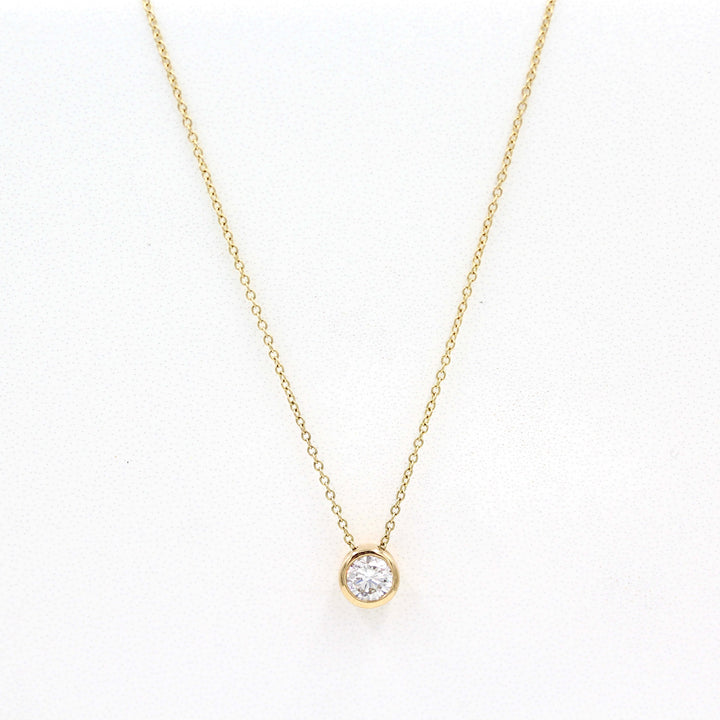 1/2ct Diamond Bezel Necklace in Yellow Gold against a white background