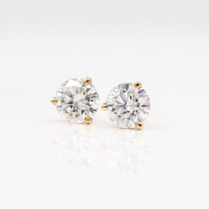 Martini Mounting Diamond Studs in yellow gold against a white background