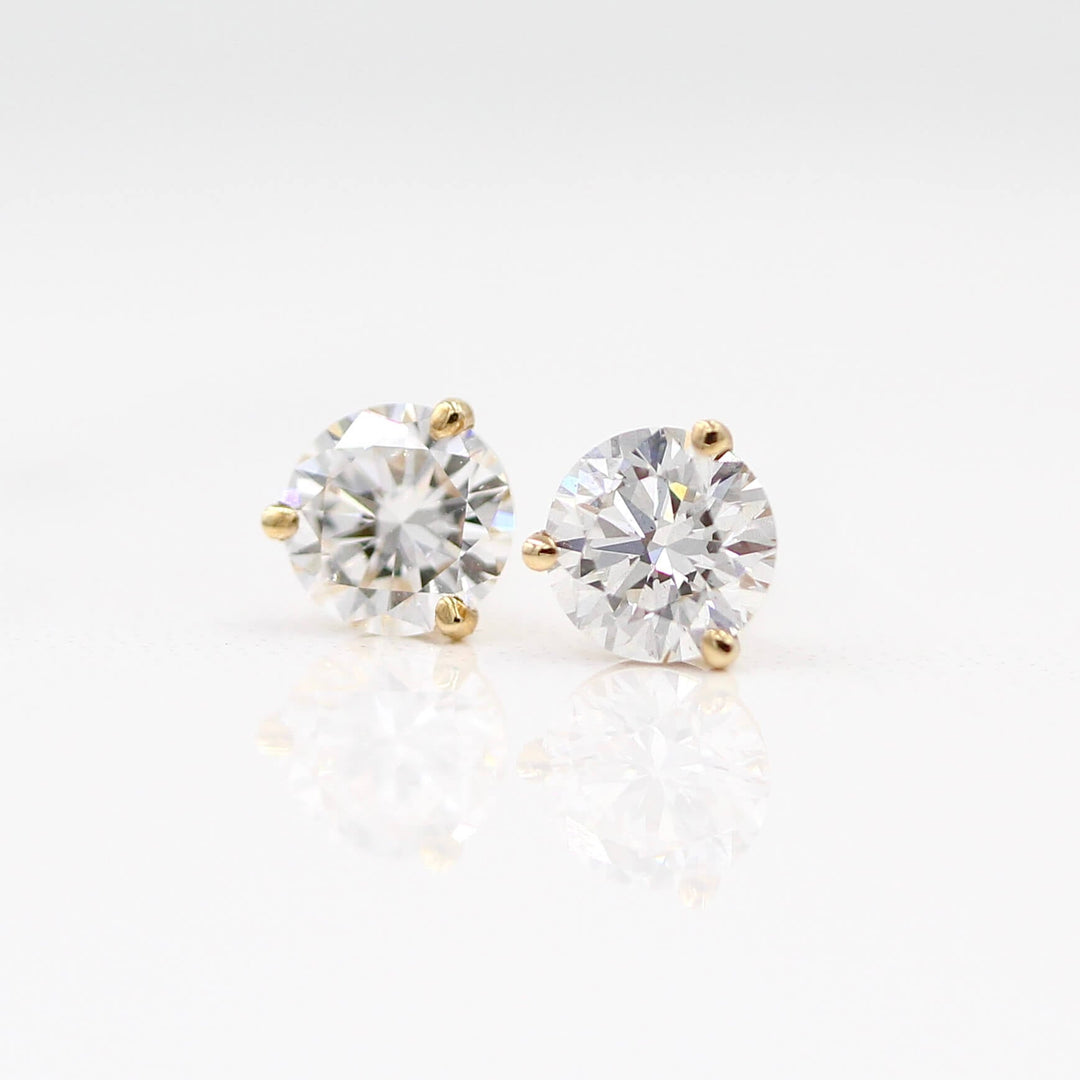 Martini Mounting Diamond Studs in yellow gold against a white background