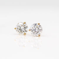 Martini Mounting Diamond Studs in yellow gold against a white background
