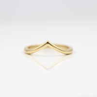 The V Wedding Band in yellow gold against a white background