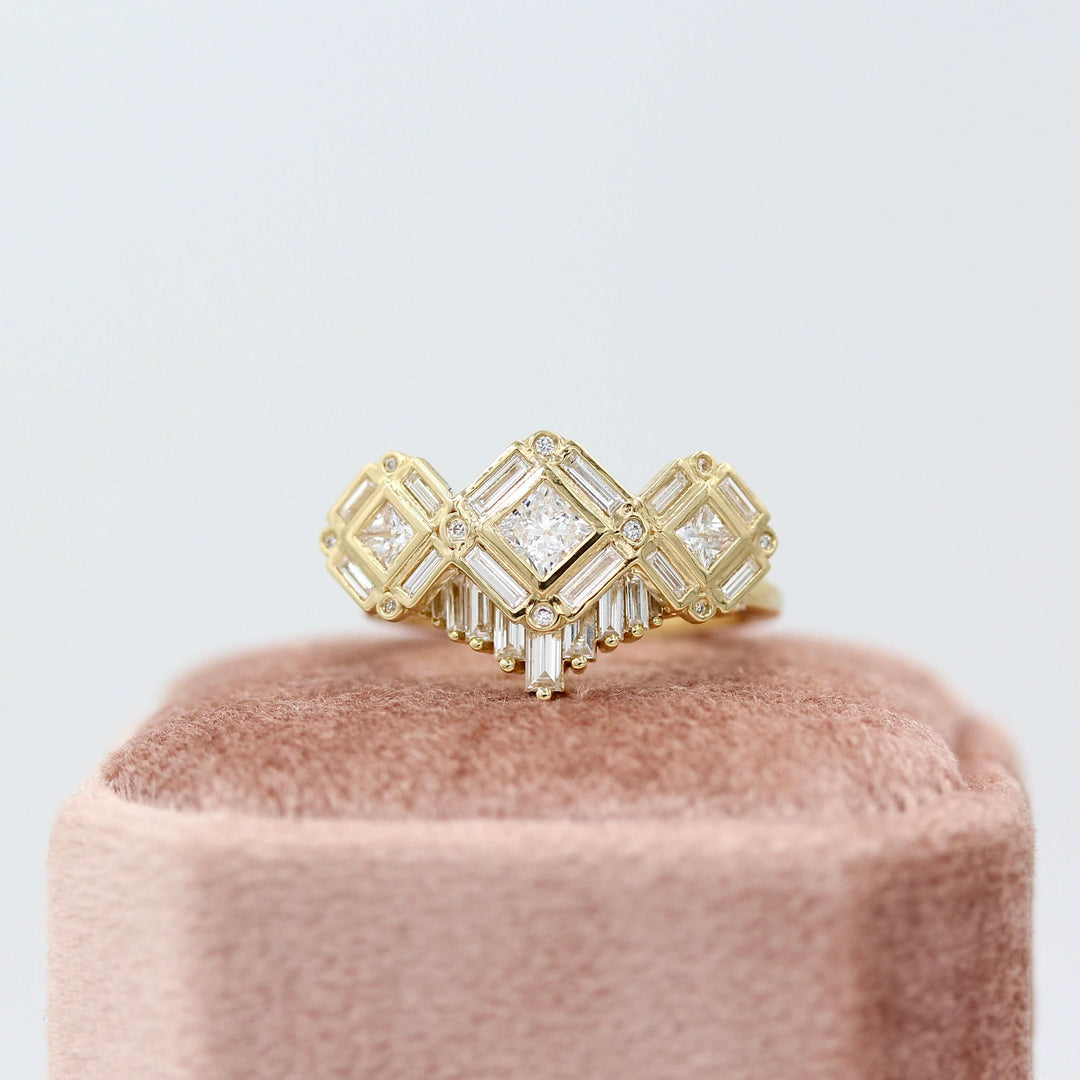 The Darby Wedding Band in Yellow Gold and the Darby Ring in Yellow Gold atop a pink velvet ring box