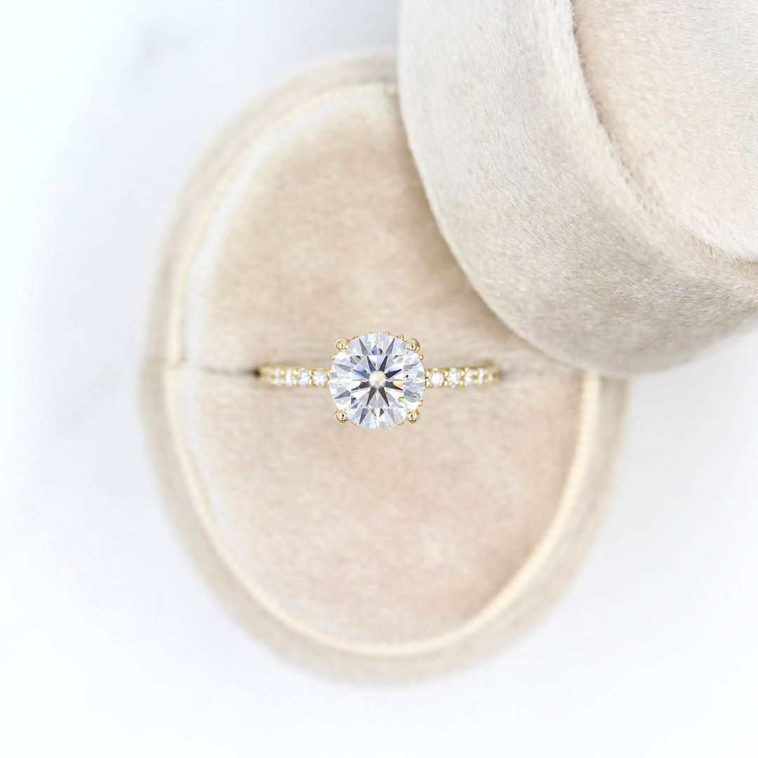 The Athena Hidden Halo Ring (Round) in Yellow Gold in a tan velvet ring box