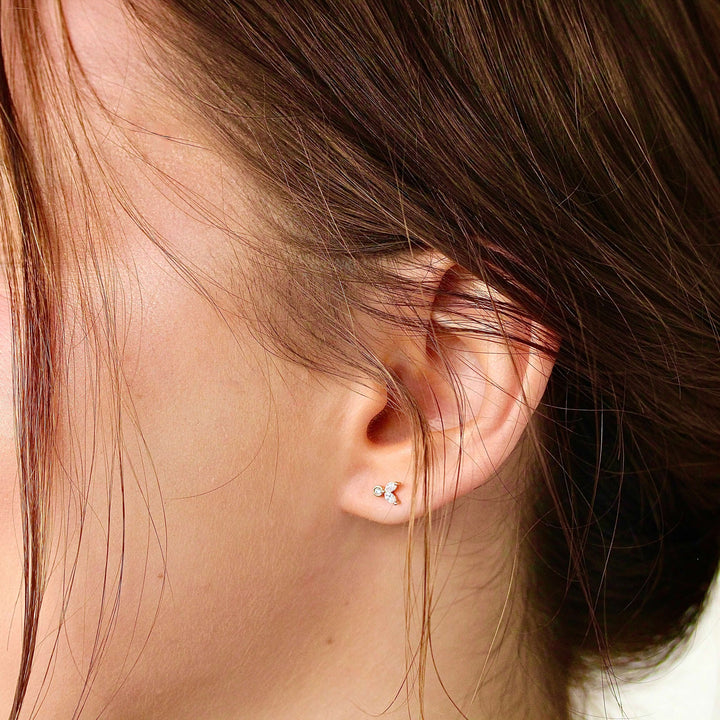 The Sophia Earrings in Rose Gold modeled on an ear