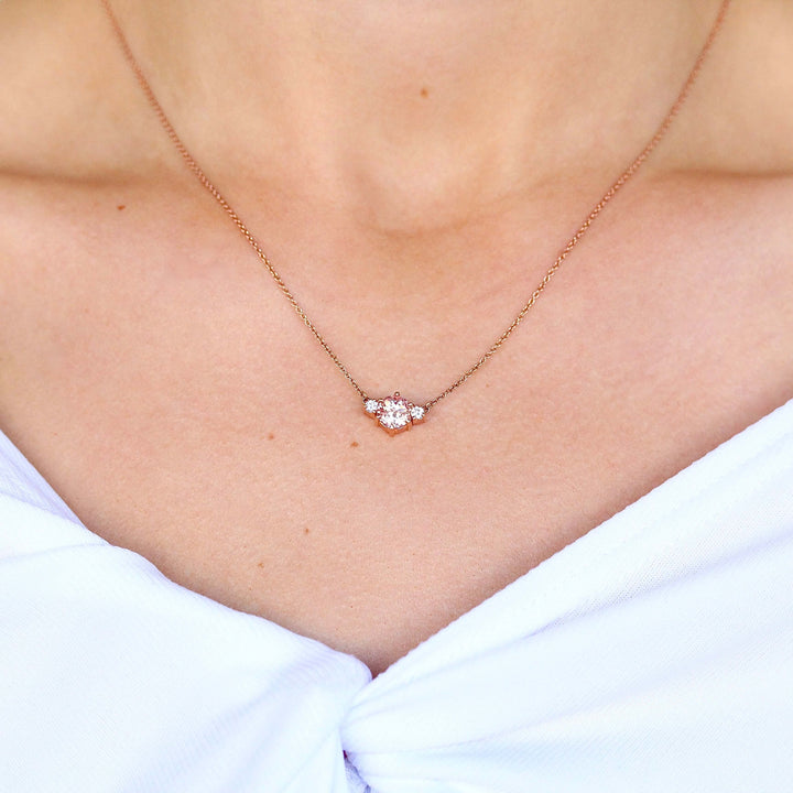 The Trio Peachy-Pink Sapphire and Diamond Necklace in rose gold modeled on a neck