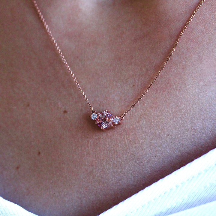 The Trio Peachy-Pink Sapphire and Diamond Necklace in rose gold modeled on a neck