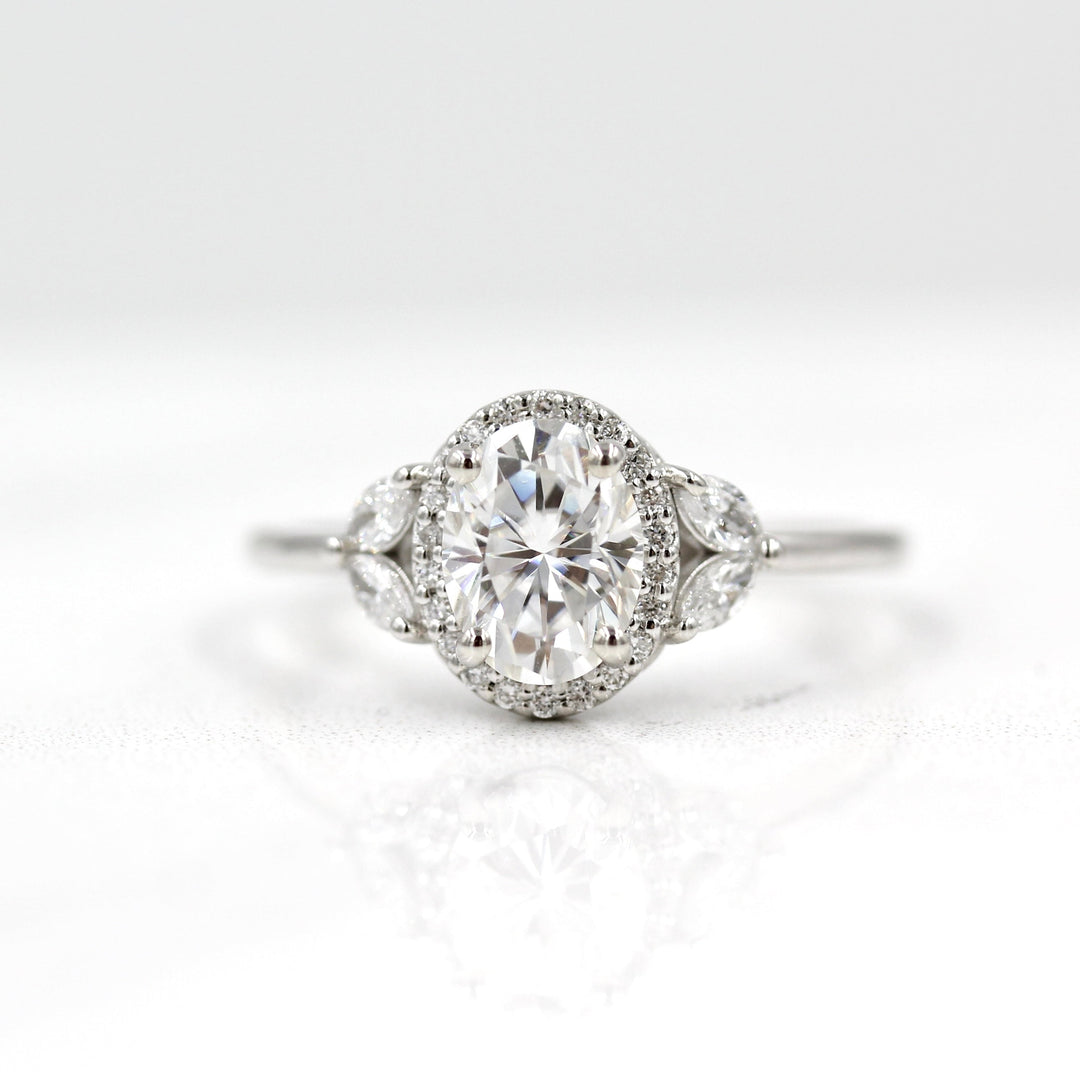 White gold oval halo engagement ring with marquise accents
