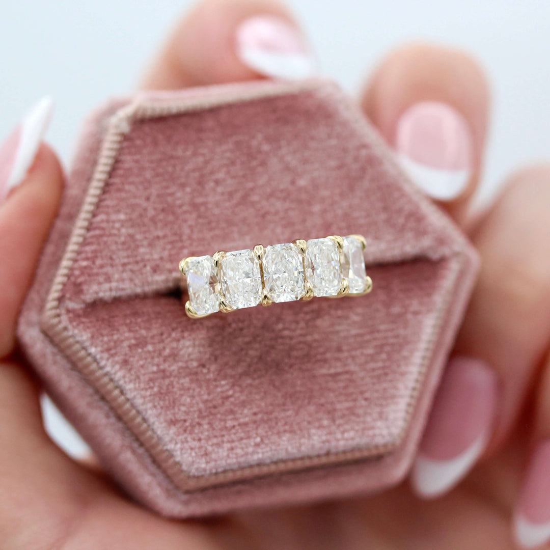 The Keeley Wedding Band in Yellow Gold in a pink velvet ring box