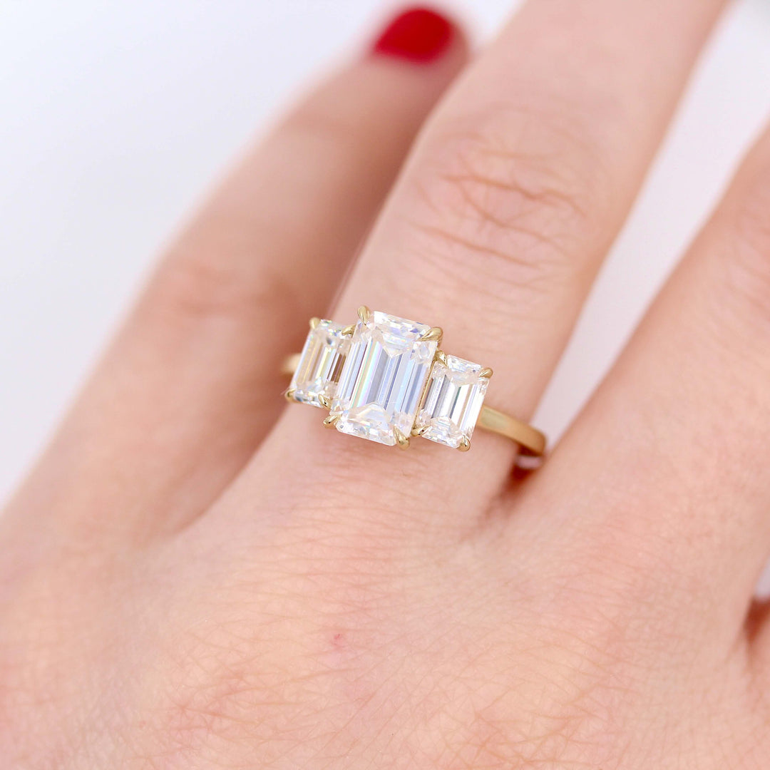 The Kendall Hidden Halo Ring in Yellow Gold with Moissanite modeled on a hand