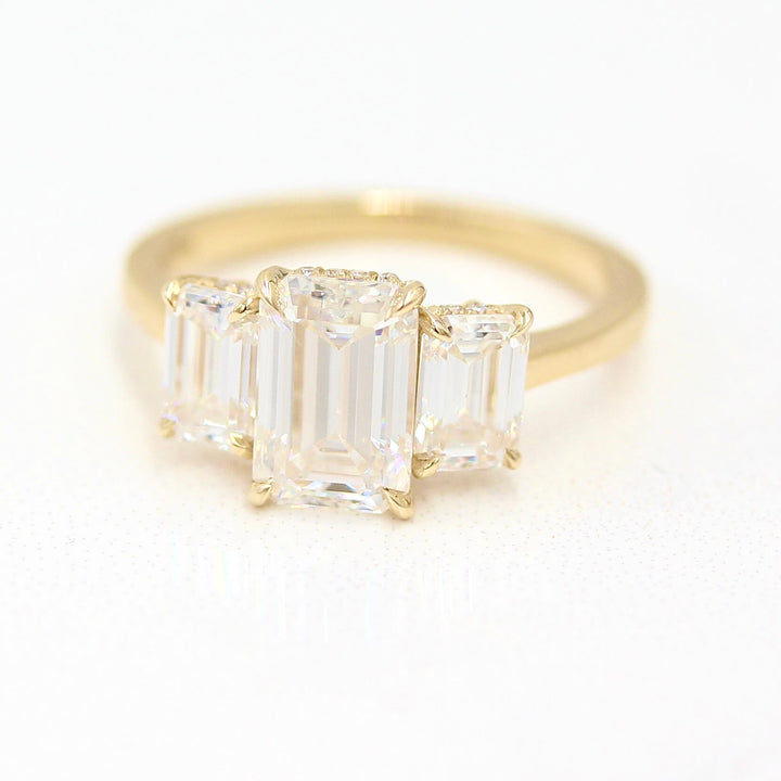 The Kendall Hidden Halo Ring in Yellow Gold with Moissanite against a white background