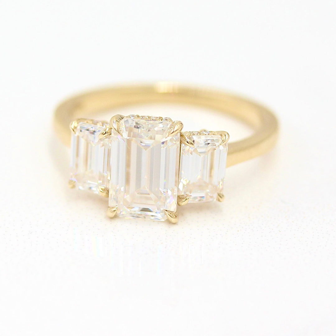 The Kendall Hidden Halo Ring in Yellow Gold with Moissanite against a white background