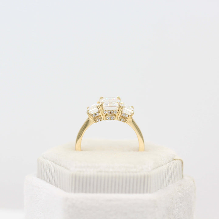 The Kendall Hidden Halo Ring in Yellow Gold with Moissanite in a white velvet ring box