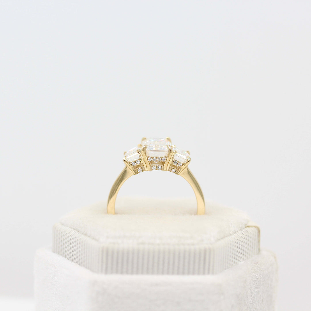 The Kendall Hidden Halo Ring in Yellow Gold with Moissanite in a white velvet ring box