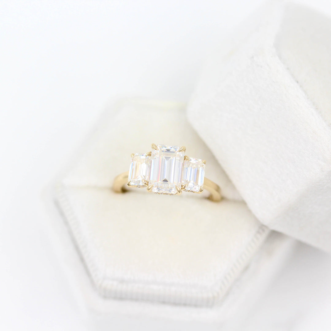 The Kendall Hidden Halo Ring in Yellow Gold with Moissanite in a white velvet ring box