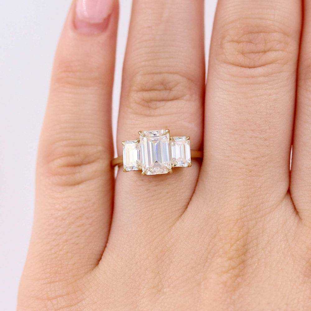 The Kendall Hidden Halo Ring in Yellow Gold with Moissanite modeled on a hand