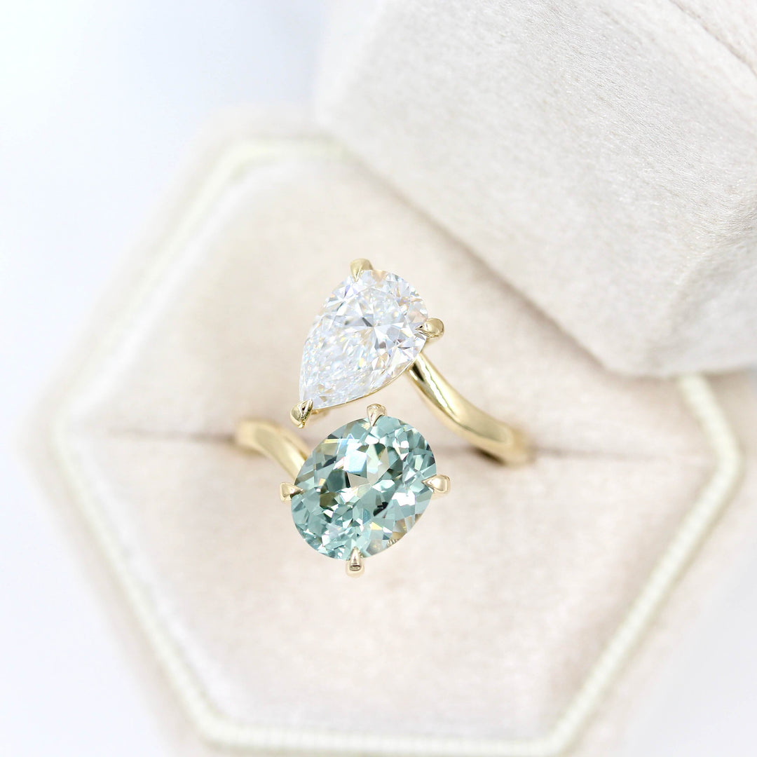 Engagement Ring 14k Yellow Gold Toi Et Moi Diamond and Sage Green Sapphire Bypass Ring in Yellow Gold in a tan velvet ring box