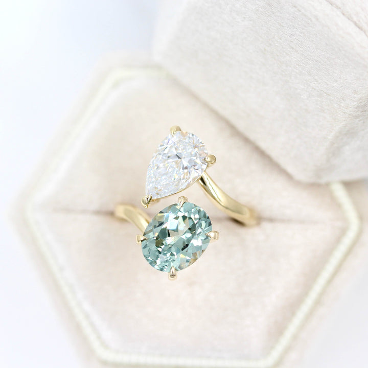 Engagement Ring 14k Yellow Gold Toi Et Moi Diamond and Sage Green Sapphire Bypass Ring in Yellow Gold in a tan velvet ring box