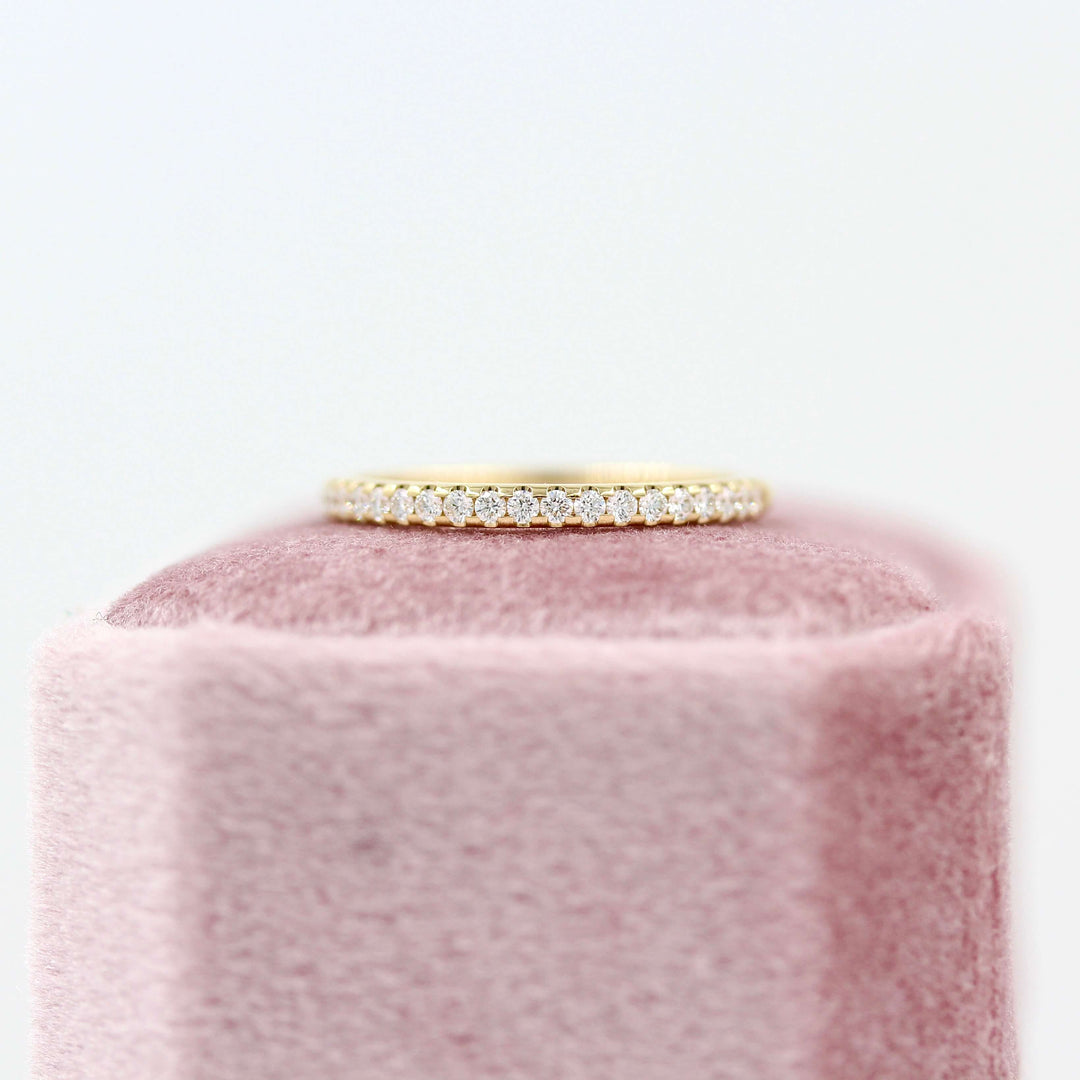 The Lauryn Wedding Band in Yellow Gold atop of a pink velvet ring box