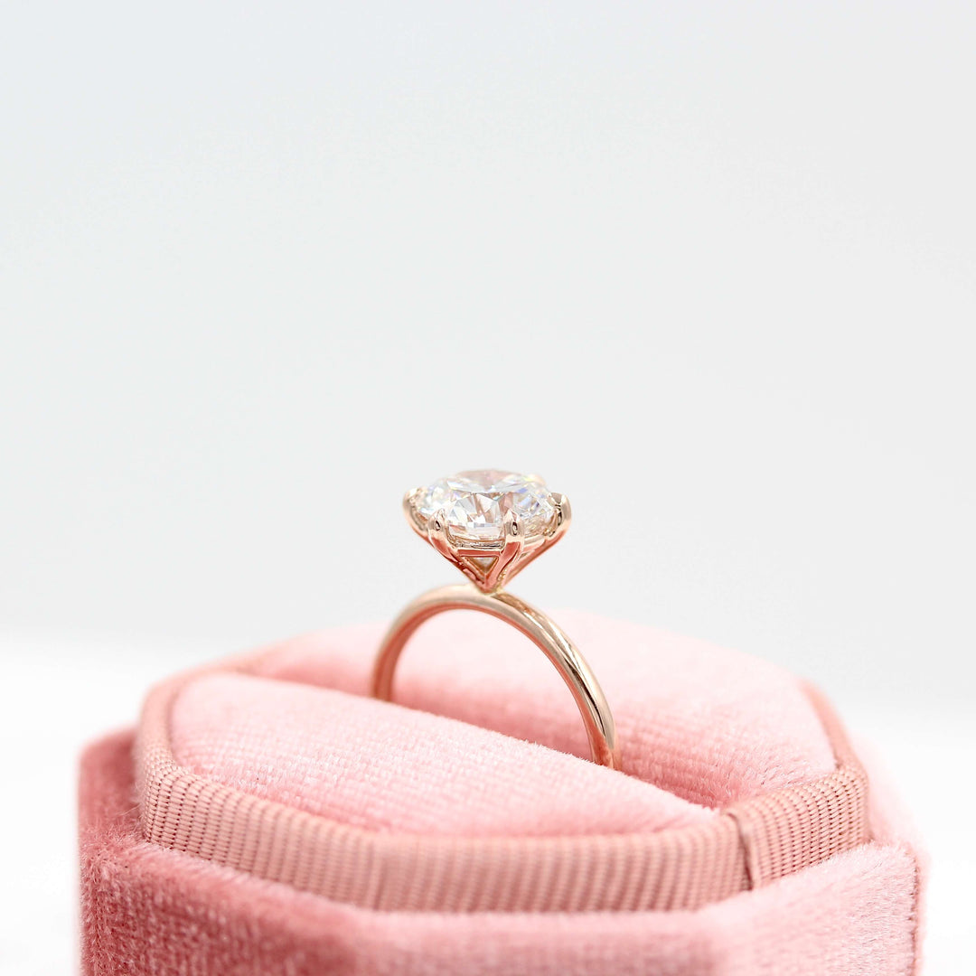The Lola ring in rose gold side profile in a pink velvet ring box