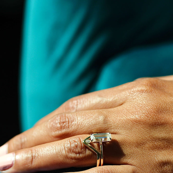 The Maeve Ring in Yellow Gold stacked with the Single Diamond V-Band in yellow gold modeled on a hand