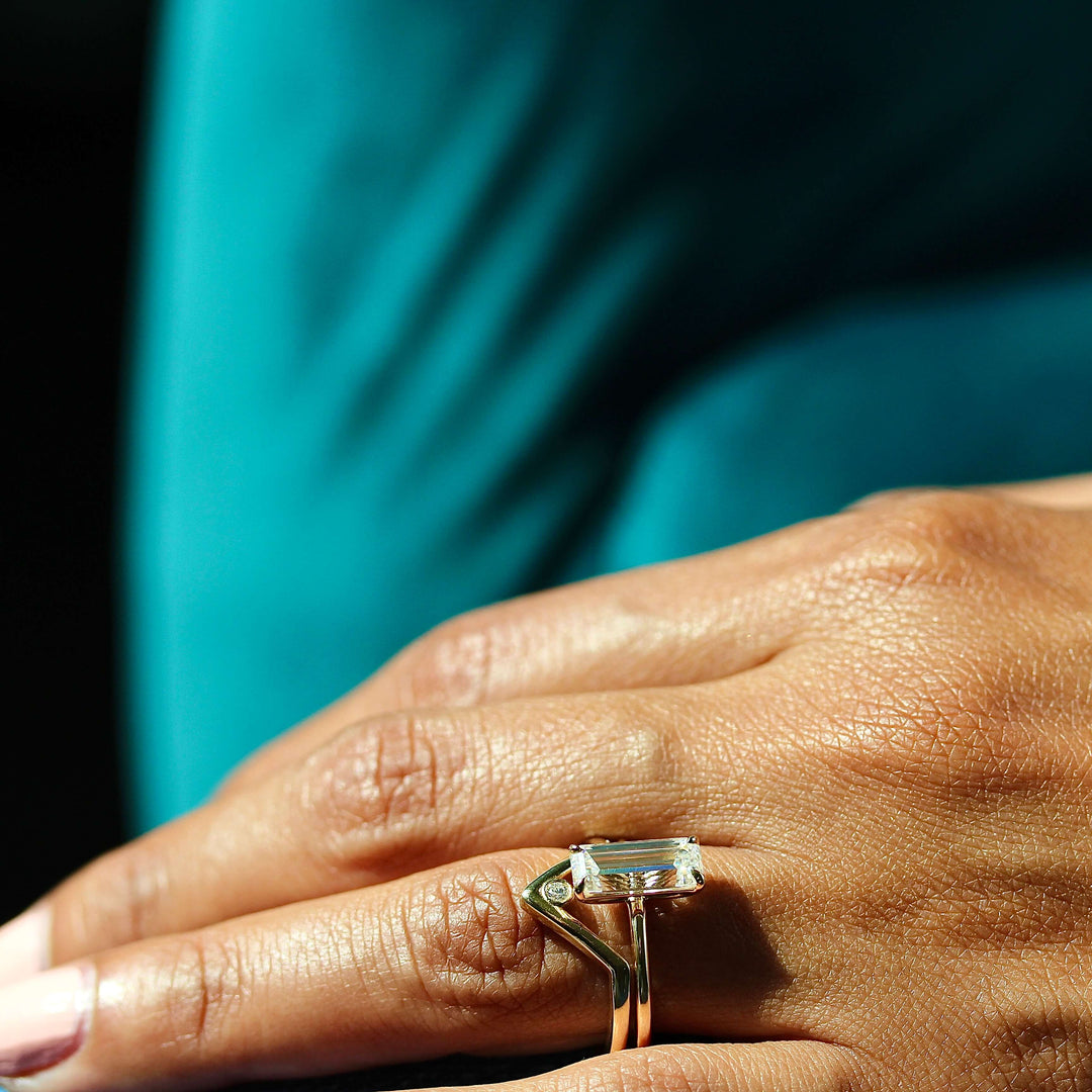 The Maeve Ring in Yellow Gold stacked with the Single Diamond V-Band in yellow gold modeled on a hand