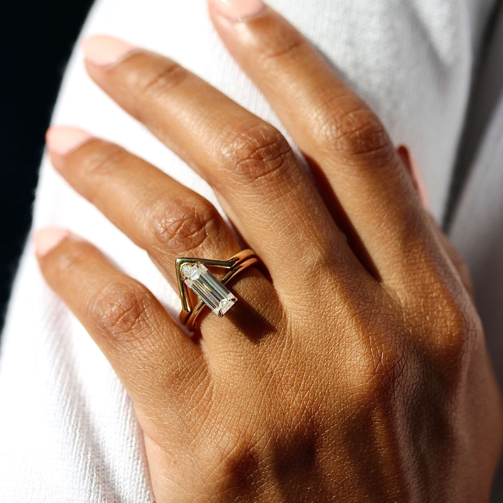 The Maeve Ring in Yellow Gold stacked with the Single Diamond V-Band in yellow gold modeled on a hand