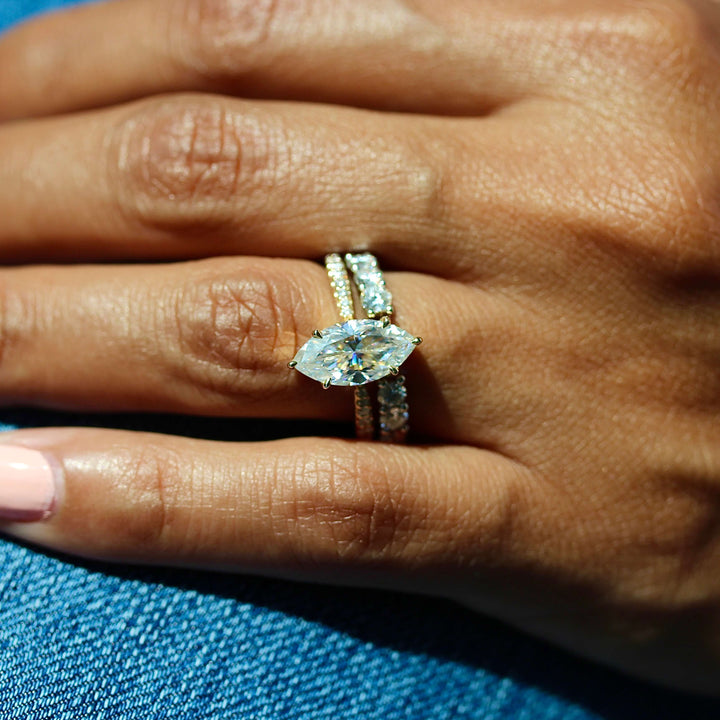 The Maisie Ring (Marquise) in Yellow Gold stacked with the Open Lexington Wedding Band in White Gold modeled on a hand